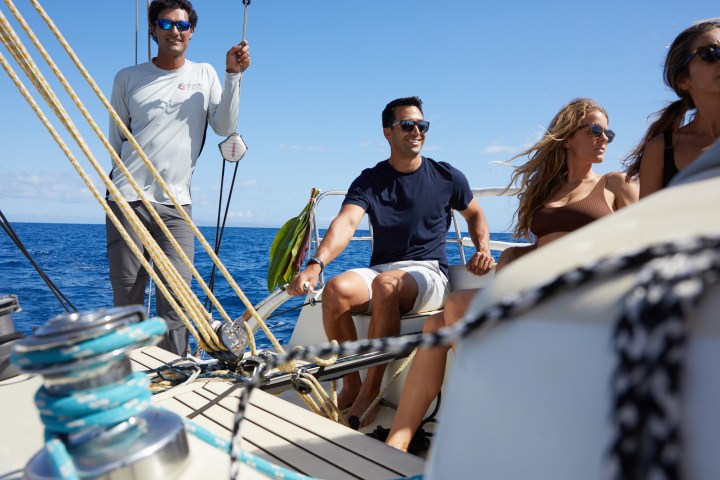 a couple of people riding on the back of a boat